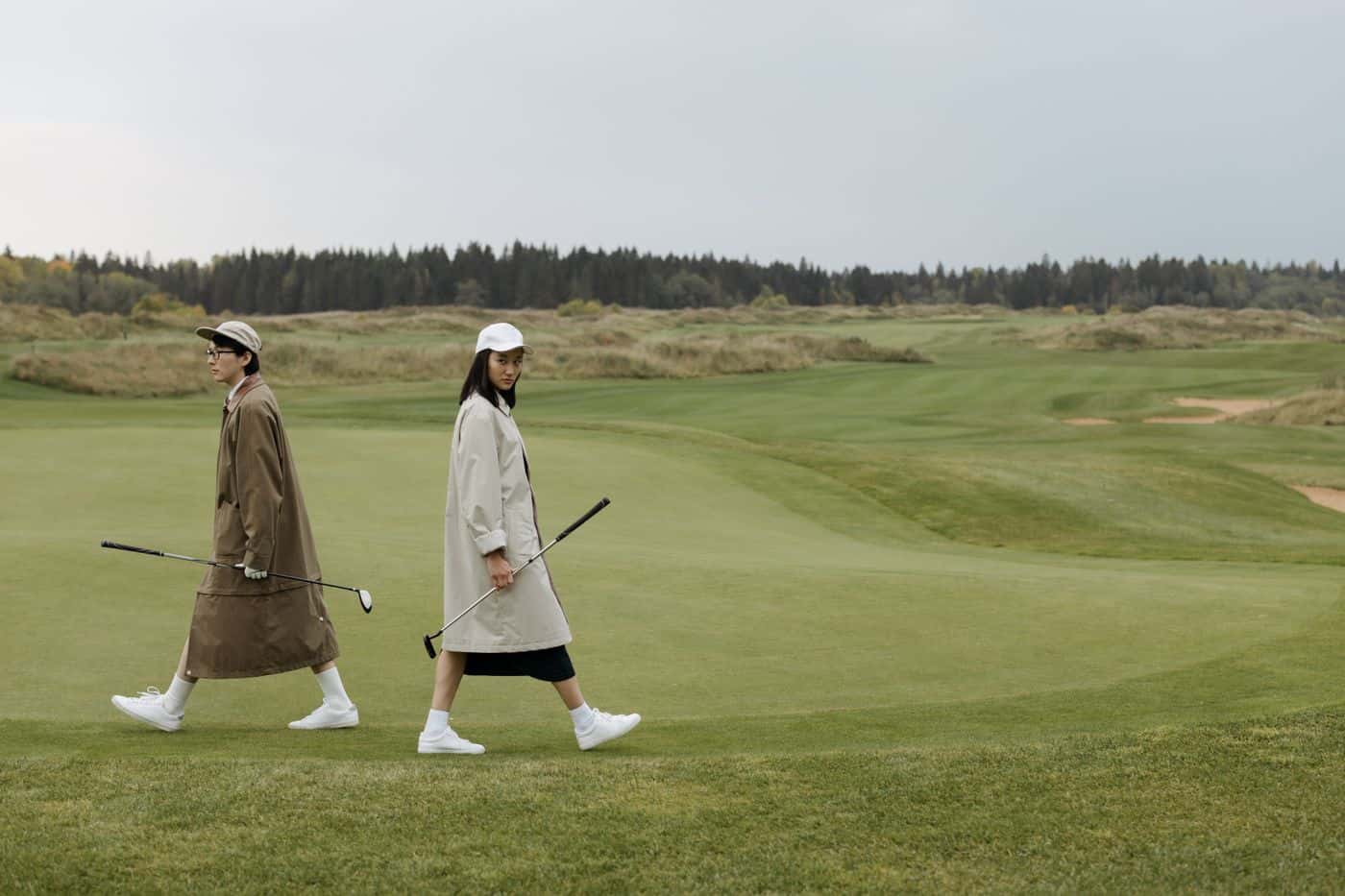 Golfers walking a fairway on a UK parkland course