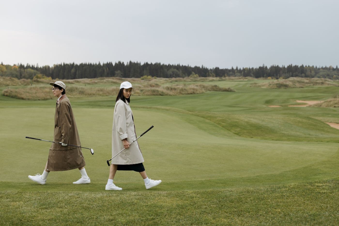 Golfers walking a fairway on a UK parkland course
